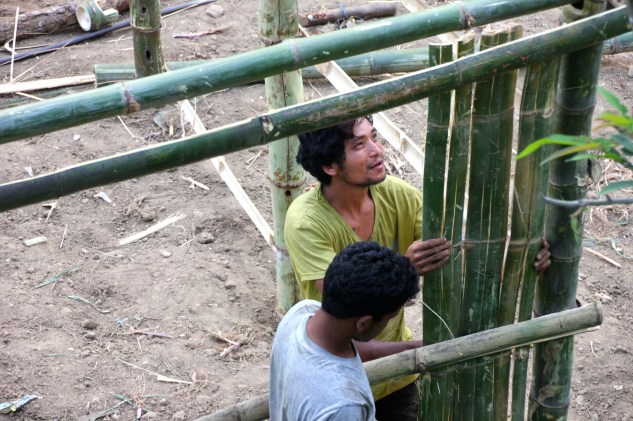 Uttam and his brother building their bamboo house